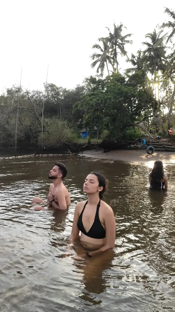 Guests standing in the river with eyes closed, breathing slowly