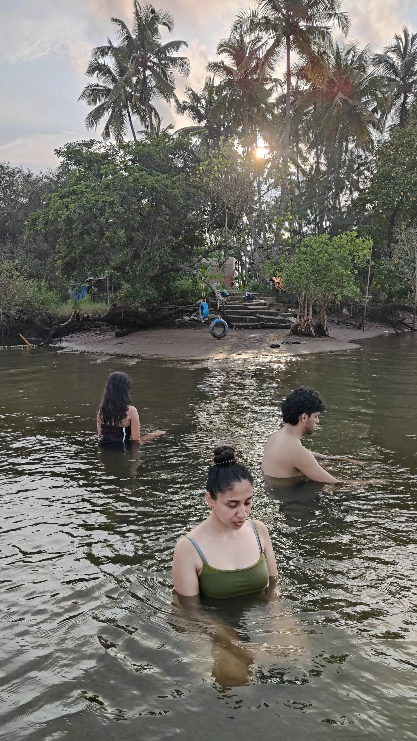 A group standing quietly in the river at golden hour