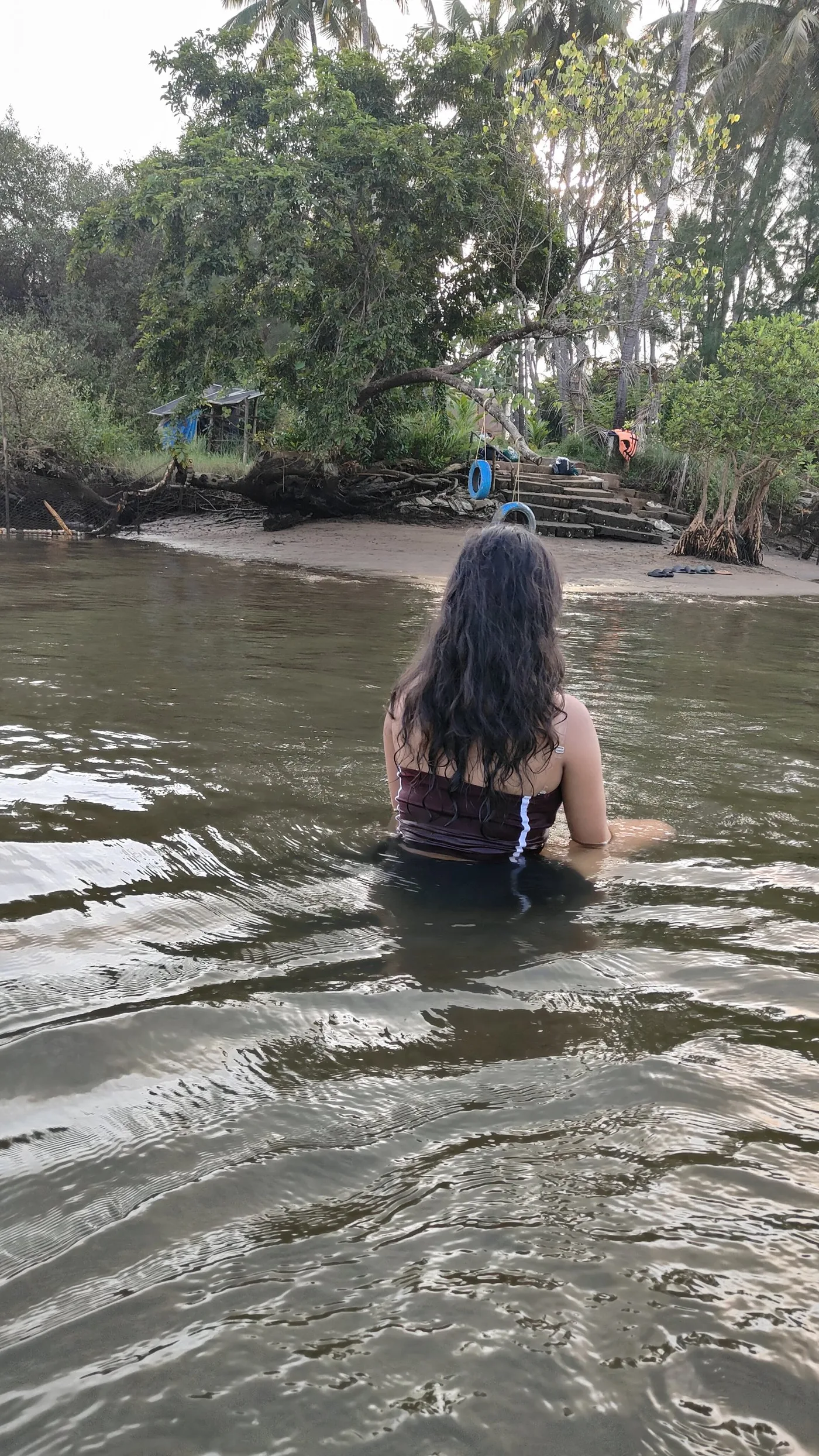A guest wading into the sweet water lake at dusk